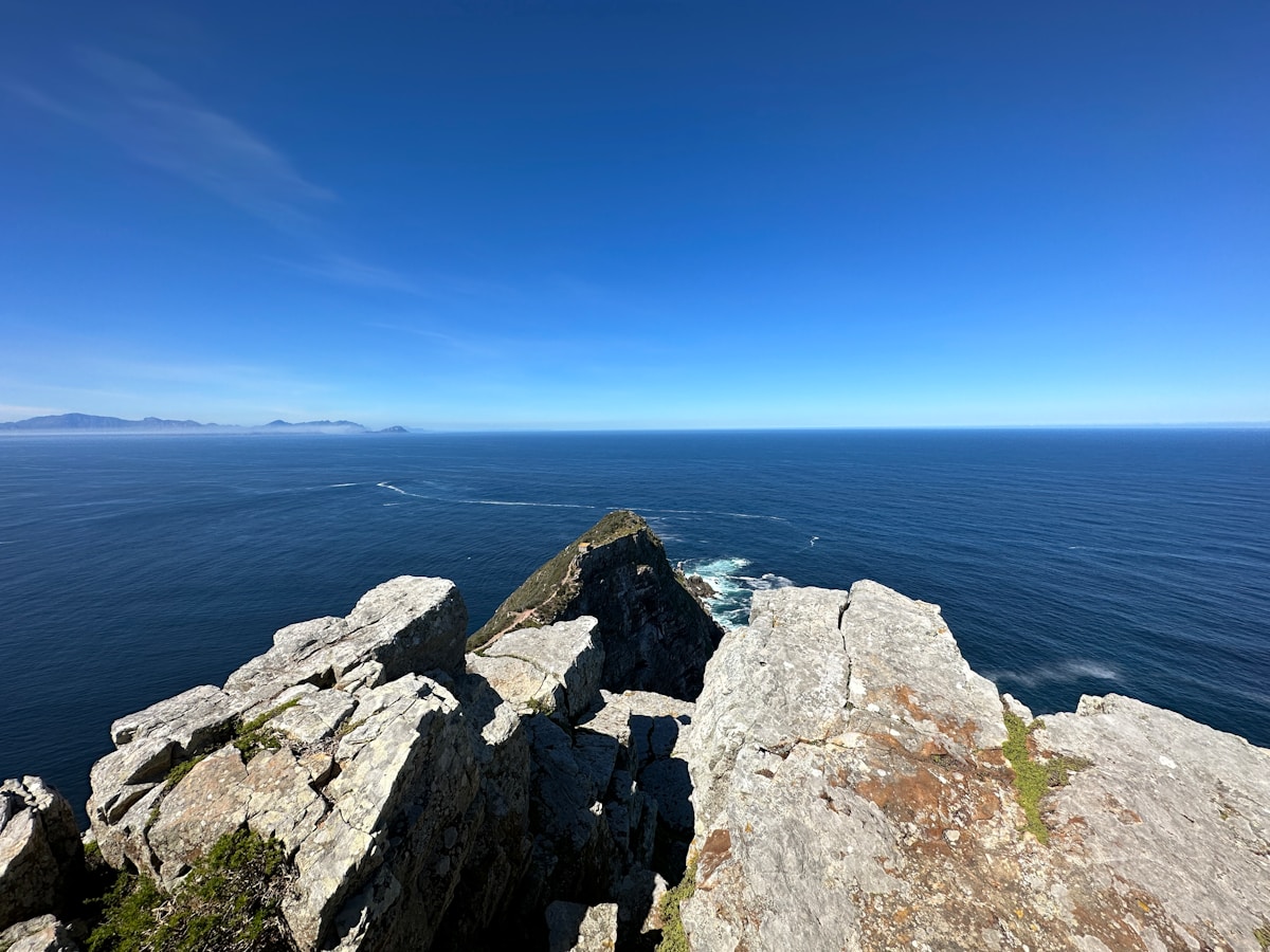 The dramatic cliffs of Cape Point with the ocean below and the lighthouse above