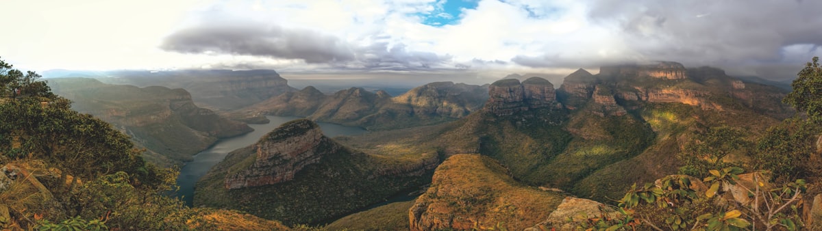 A composite of South Africa highlights — Table Mountain, a Kruger elephant, and a Garden Route coastline